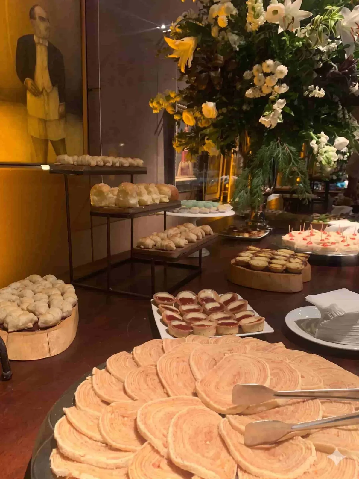 Mesa completa de buffet corporativo em Recife com pães, doces e salgados